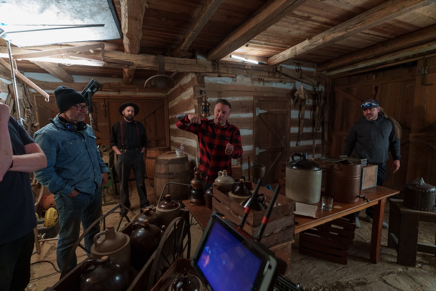 The crew setting up inside a log cabin bar.